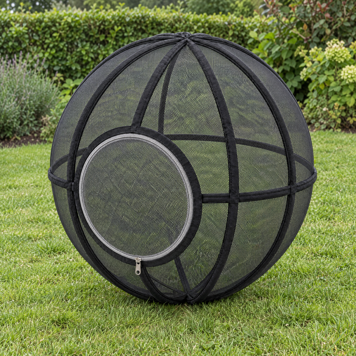 Whisker Wheel cat exercise ball in Black on a garden lawn
